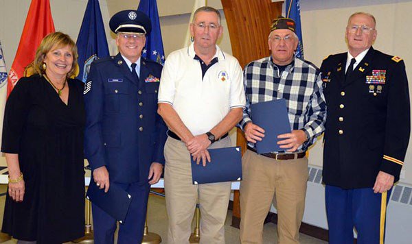 First Lady Ann LePage &#40;L&#41; and Lt. Col. Peter Ogden &#40;R&#41; pose with three borther of the Dumond Family,