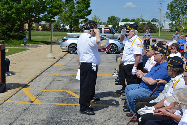 Commander Gary Stewart presenting the Vietnam War Commemoration Pin to Richard Schussman