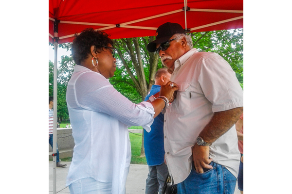 A Vietnam Veteran receives his Vietnam Veterans Lapel Pin