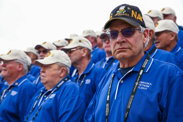 A Vietnam Veteran stands on the steps of the Lincoln Memorial.