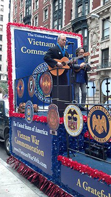 Singer Chris Van Cleave and violinist Cecil Hooker make their way up 5th Avenue in New York City