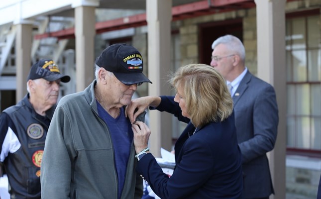 U.S. Rep. Claudia Tenney &#40;NY-24&#41; pins a Vietnam veteran.