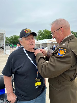 VWC Director, U.S. Army Maj. Gen. Edward J. pins a lapel pin on a Vietnam veteran at &#34;Welcome Home.&#34;