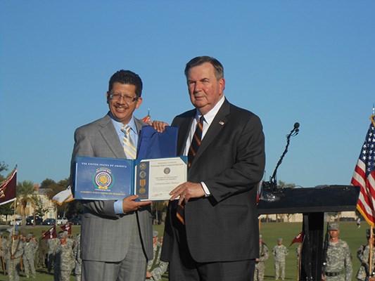 Mr. Richard Perez, President of the Greater San Antonio Chamber of Commerce accepts the flag and cer