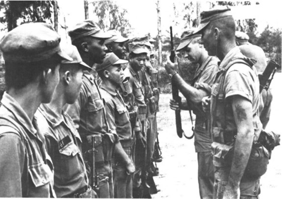 At Phu Bai, 1st Lieutenant Paul R. Ek, commander of the Combined Action Company &#40;holding the rifle&#41;,