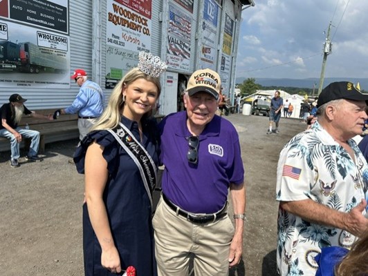 The County Fair Queen pictured with a veteran.