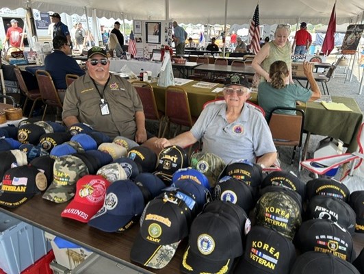 Veterans sell caps at the fair.