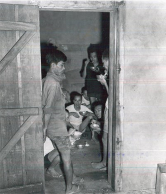 Prisoners eat a meal in their cell at Con Son Prison, which would later become the sight of the infa