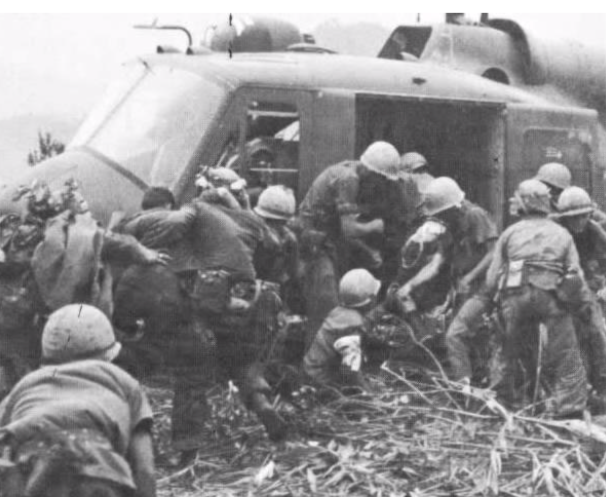 Photo of Marines evacuating the wounded from Company I into a helicopter after fighting on Hill 362 (USMC).
