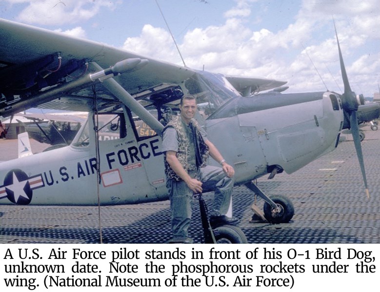 Photo of pilot standing in front of Bird Dog.