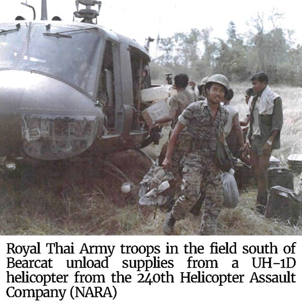Photo of Royal Thai Army troops in the field south of Bearcat unload supplies from a UH-1D helicopter from the 240th Helicopter Assault Company (NARA)