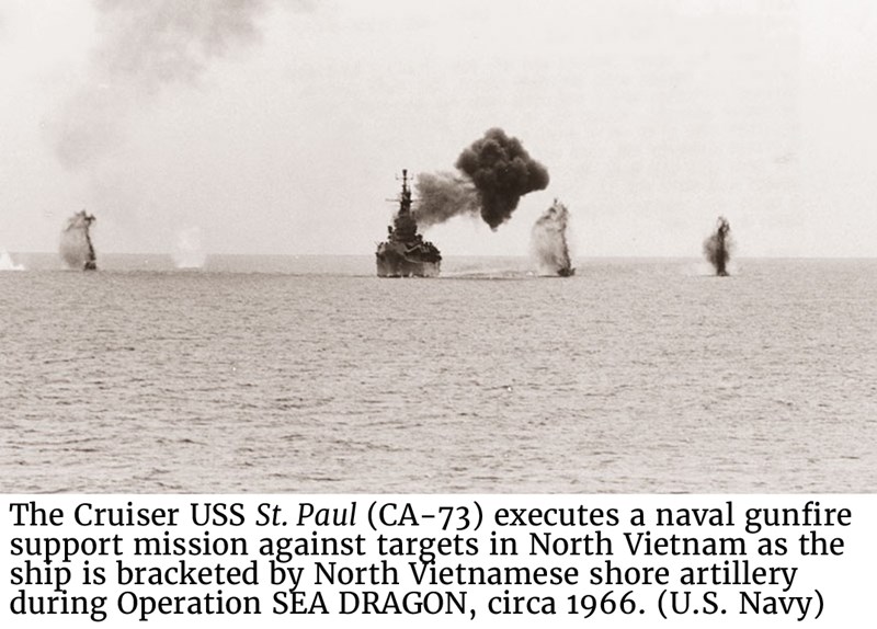 The Cruiser USS St. Paul (CA-73) executes a naval gunfire support mission against targets in North Vietnam as the ship is bracketed by North Vietnamese shore artillery during Operation SEA DRAGON, circa 1966. (U.S. Navy)