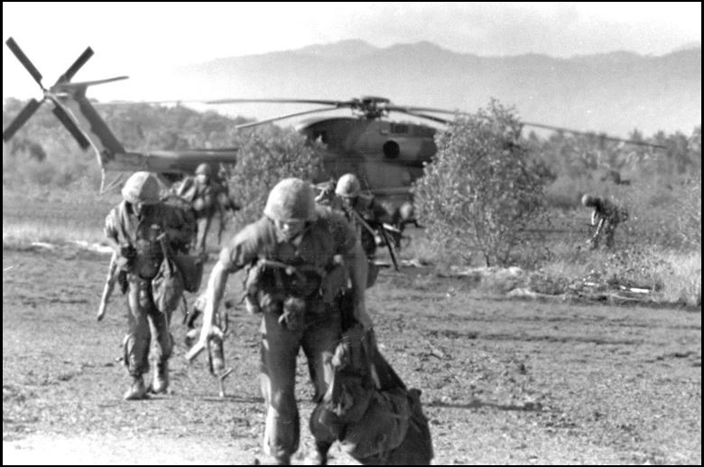 Marines offloading from a CH-53 Sea Stallion helicopter after landing on Koh Tang island, May 15, 1975. (U.S. Air Force)