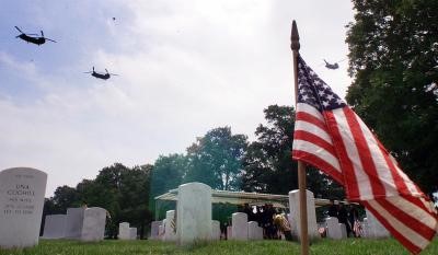 CH-53 Chinook Helicopters execute the "Missing man" formation over Arlington National Cemetery on the day all five crewmen were interred there, May 25, 2001.