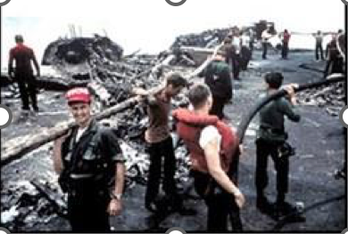 U.S. Navy-provided photo of Sailors working to clear debris in the aftermath of the fire on July 29, 1967
