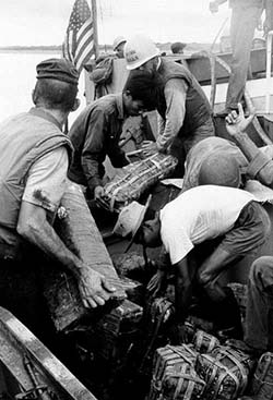 U.S. and South Vietnamese Personnel Unload Ammunition